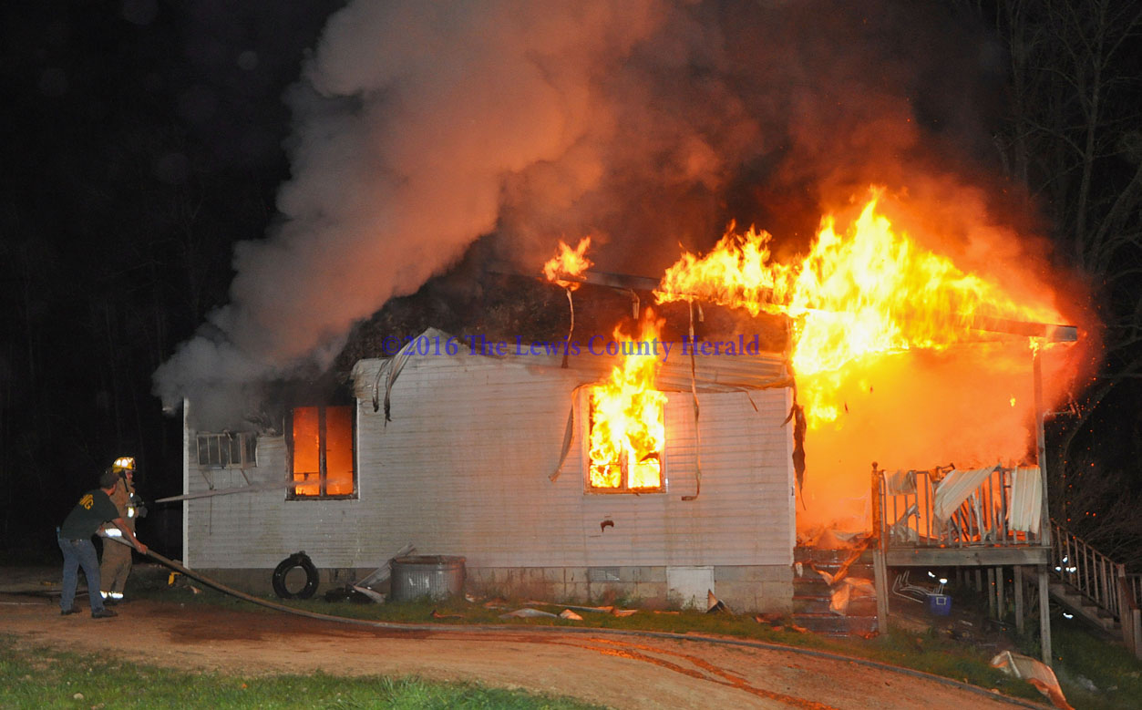 Firefighters battle a fire at a home on Rock Run Road near Vanceburg. - Photo by Dennis Brown