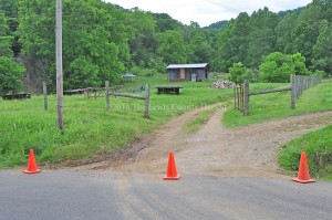 Orange traffic cones block a driveway leading to the home of Kevin and Crystal Love Ball on Sunday afternoon.