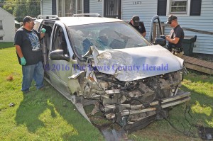 First responders examine the scene of an accident Monday afternoon at Quincy. A Vanceburg woman was injured in the crash. - Photo by Dennis Brown