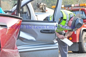 KSP Trooper Thurman Paige collects information following an accident on the AA Highway at Clarksburg Wednesday morning. - Dennis Brown photo 
